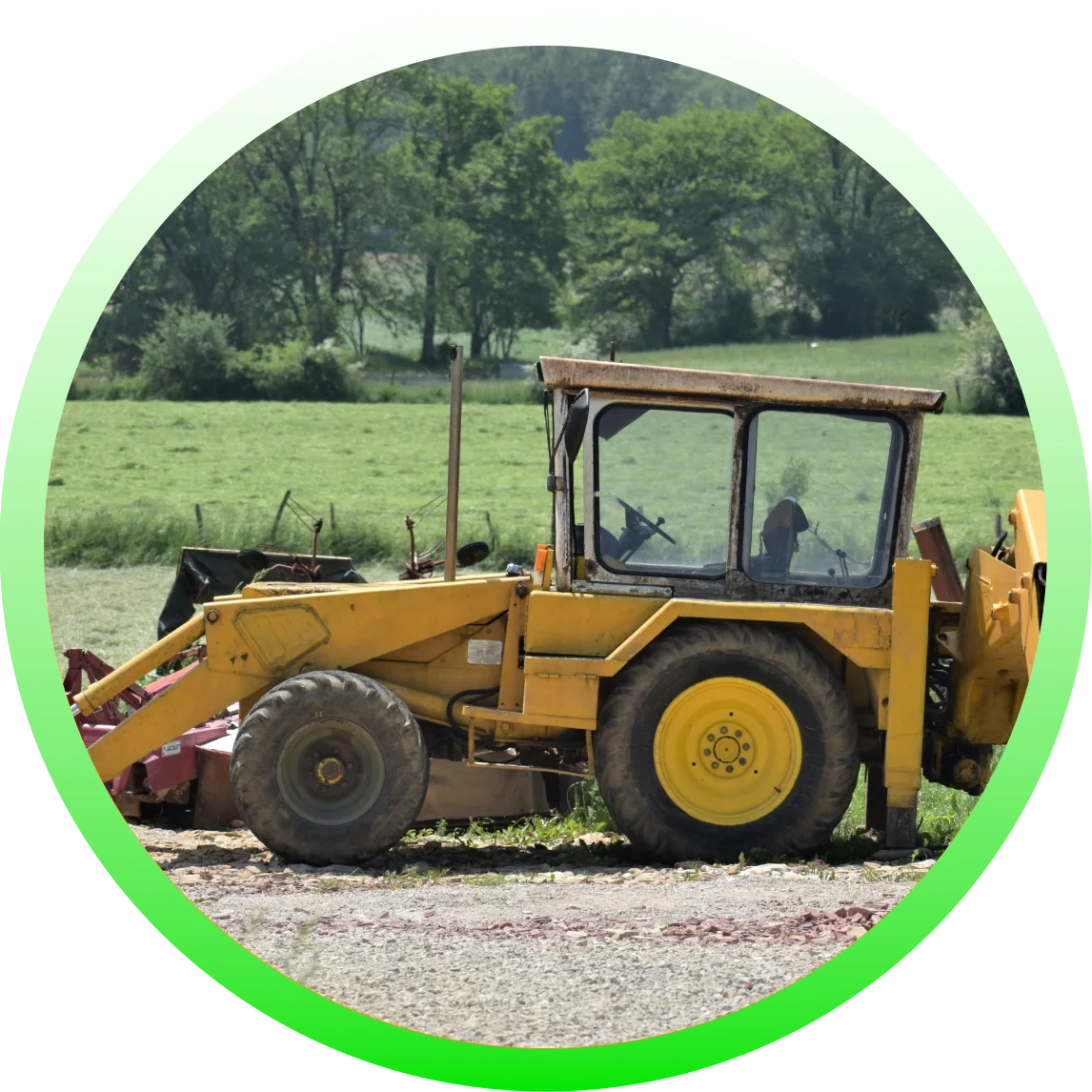 A yellow tractor is parked on the side of a road.